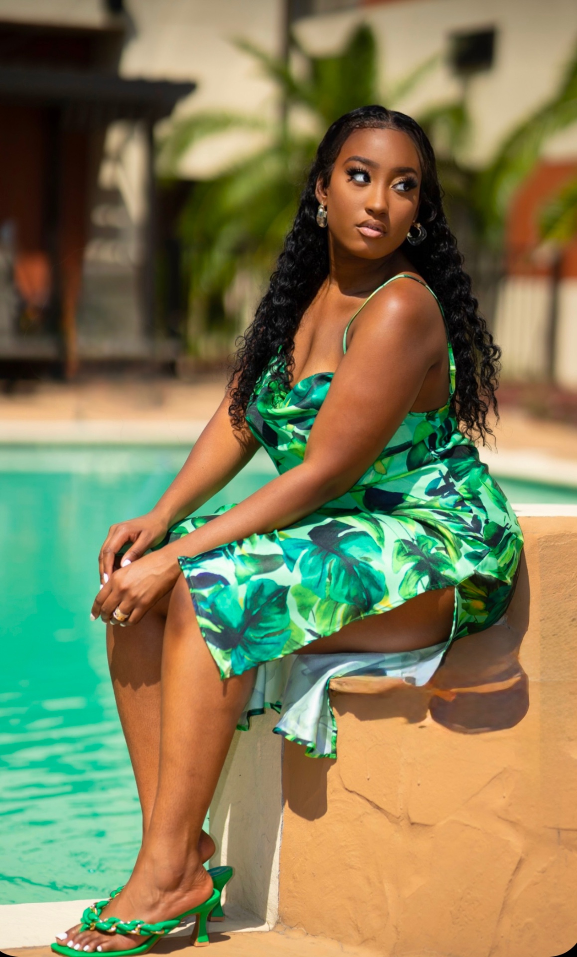 Travel companion poolside at a private resort villa in green silk